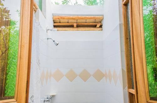 a bathroom with a toilet and a window at Hostal Renacer in Villa de Leyva