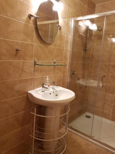 a bathroom with a sink and a shower at Ethan House Holiday Suites in Killarney