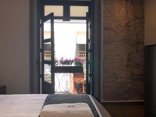 a bedroom with an open door to a balcony at Hotel Isabel in Puebla