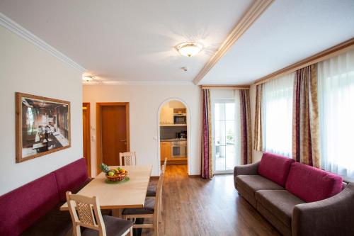 a living room with a couch and a table at ALPENAPART LADIS ehemals Alpenapart Alexander in Ladis