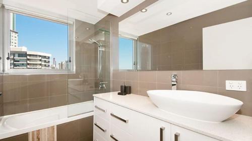 a bathroom with a sink and a shower and a tub at Amira Penthouse Main Beach in Gold Coast