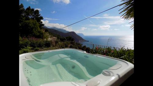a jacuzzi tub with a view of the ocean at C'an Co Banyalbufar in Banyalbufar