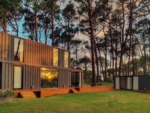 a modern house with glass windows on a lawn at La Uruguaya in Ocean Park