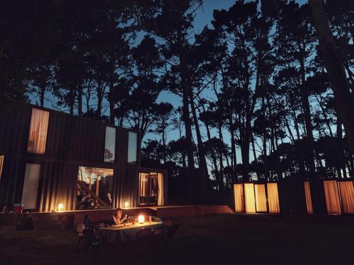 a person sitting at a table in front of a house at La Uruguaya in Ocean Park