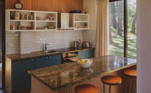 a kitchen with a counter with a bowl of fruit on it at La Uruguaya in Ocean Park