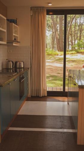 a kitchen with a counter and a large window at La Uruguaya in Ocean Park