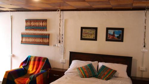 Una cama o camas en una habitación de Hospedaje Los Ponchos