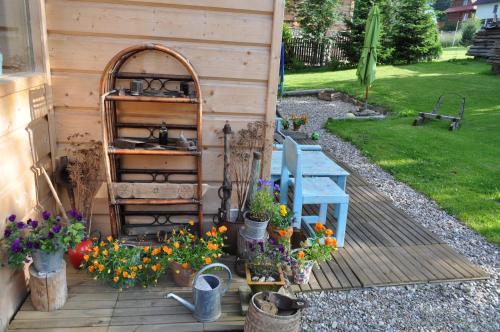 a garden with flowers and a bench and a shed at Legenda Tatr in Zakopane