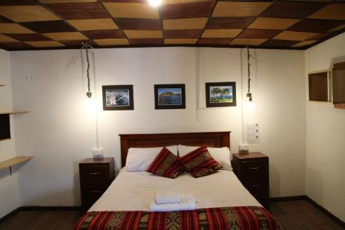 מיטה או מיטות בחדר ב-Hospedaje Los Ponchos
