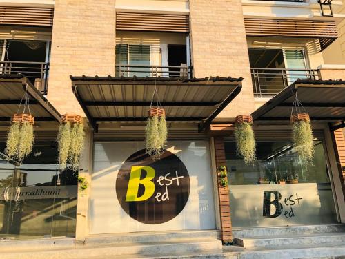 a store with a best dad sign in the window at Best Bed Suvarnabhumi Hostel in Lat Krabang