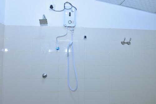 a bathroom with a shower with a blue light at Brookline Safari Resort in Udawalawe