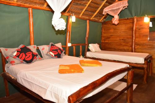a bedroom with two beds with towels on them at Brookline Safari Resort in Udawalawe