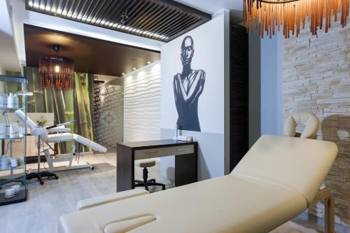 a salon with a white couch and a chair at Nawigator SPA in Rewal