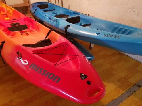 two kayaks are sitting on a wooden floor at Yogi-Homestay in Koror
