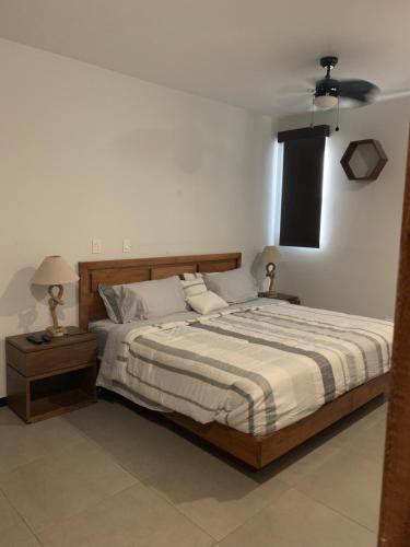 a bedroom with a large bed and a window at El Refugio in Ensenada