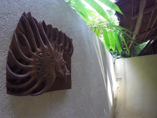a metal plate on the side of a wall at Nomad Divers Bangka in Manado