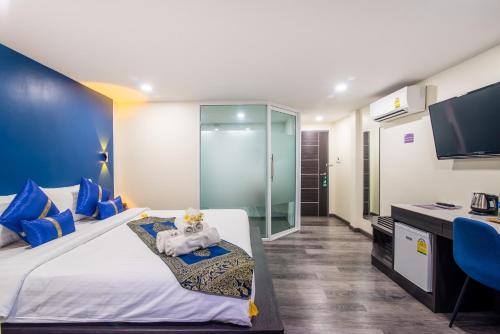 a hotel room with a bed and a tv at Anchan Hotel & Spa in Hua Hin