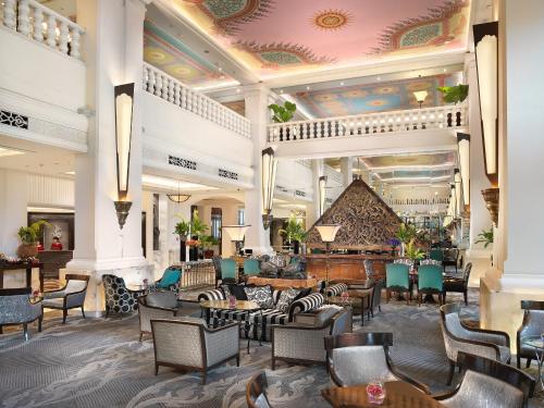 a lobby of a hotel with chairs and tables at Anantara Siam Bangkok Hotel in Bangkok