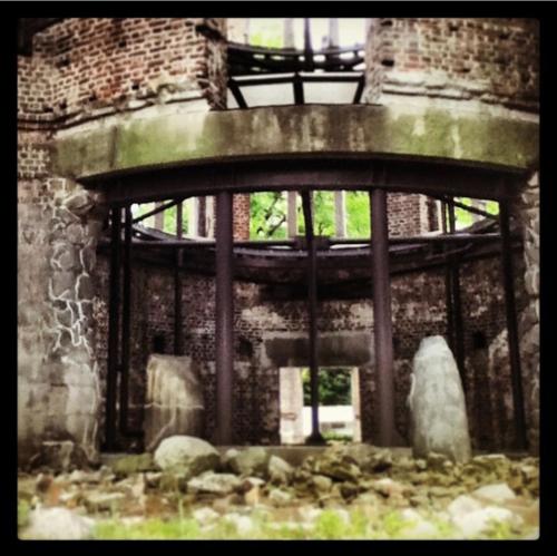 an old brick building with a window and some rocks at Guesthouse POPTONE in Hiroshima