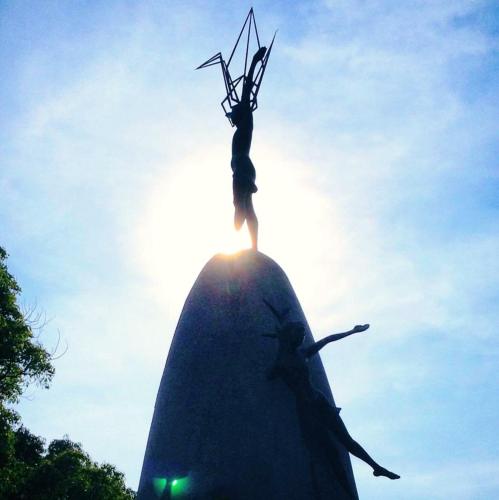a statue of a woman standing on top of a rock at Guesthouse POPTONE in Hiroshima