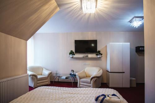a hotel room with a bed and a television at HOTEL LORD in Stargard