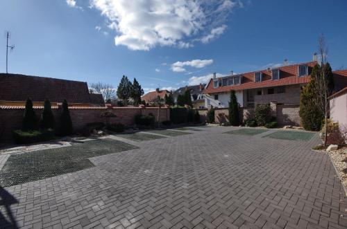 a brick driveway in front of a house at Royal Residence Apartments in Gyula