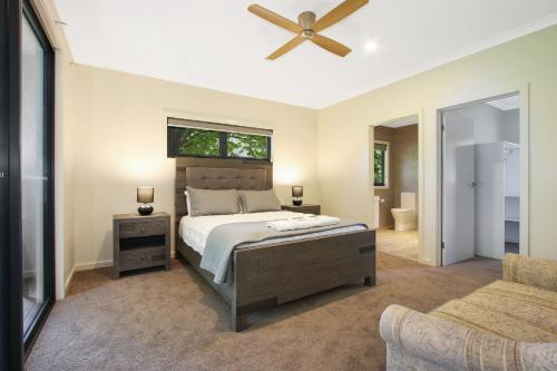 a bedroom with a bed and a ceiling fan at Telluride in Harrietville