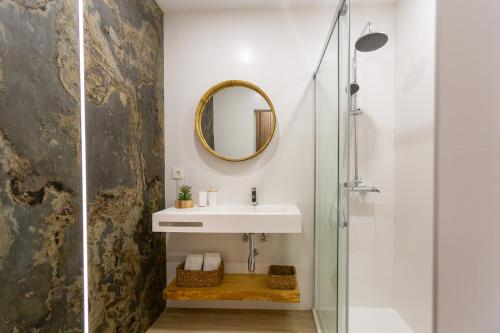 a bathroom with a sink and a mirror at Bohemian Loft - Las Canteras Beach in Las Palmas de Gran Canaria
