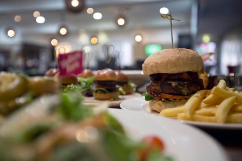 a plate of food with a hamburger and french fries at The Lord Forrest Hotel in Bunbury