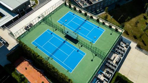 an overhead view of two tennis courts on a tennis court at Becamex Hotel New City in Thu Dau Mot