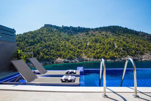 a swimming pool with a view of a mountain at Braunis Horio Villas in Asos