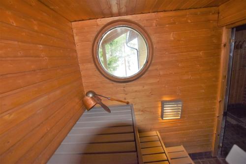 a small room with a window and a staircase at Pyhtään Vuokramökit in Tuuski