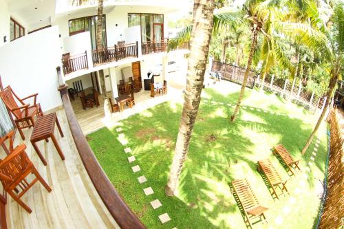 an aerial view of a house with a yard with palm trees at Bay Hiriketiya in Hiriketiya