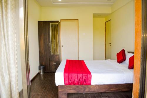 a bedroom with a bed with a red blanket at Vivaant Retreat and Conventions in Igatpuri