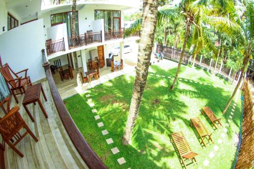 an aerial view of a house with a yard with palm trees at Bay Hiriketiya in Hiriketiya