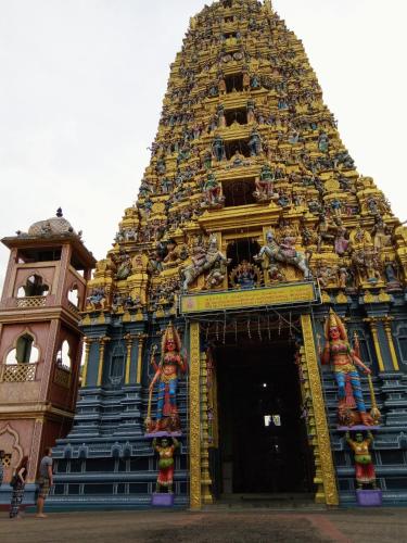 a large blue and yellow building with a tower at The Inn At Matale in Matale