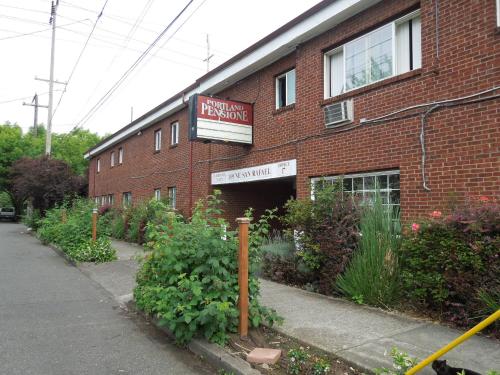 a brick building with a sign on the side of it at Portland Pensione in Portland