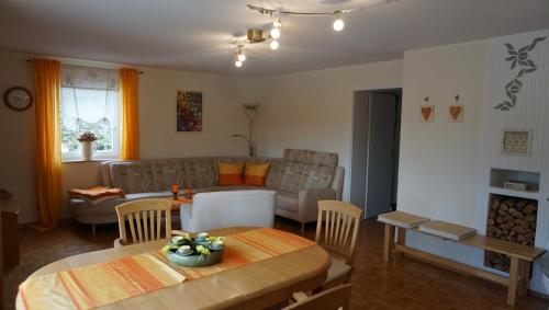 a living room with a table and a couch at Ferienwohnung Ott in Beerheide