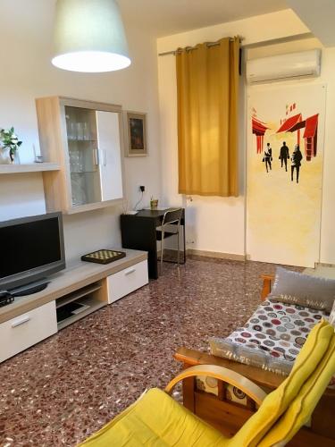 a living room with a flat screen tv and a couch at Vittoria Colonna in Vittoria