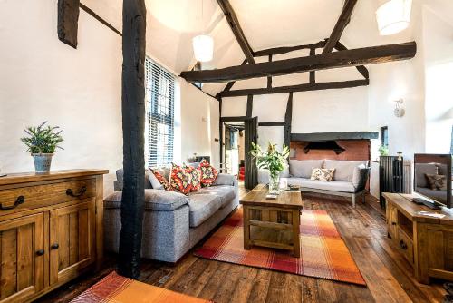 a living room with a couch and a table at Burnside Hotel in Stratford-upon-Avon