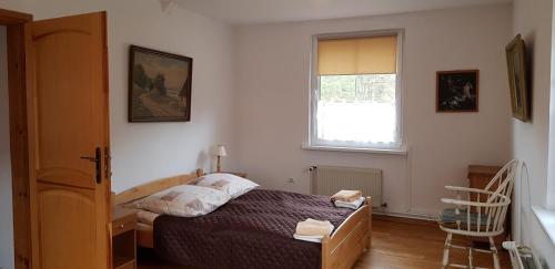 Posteľ alebo postele v izbe v ubytovaní Apartamenty Drewniany Dom