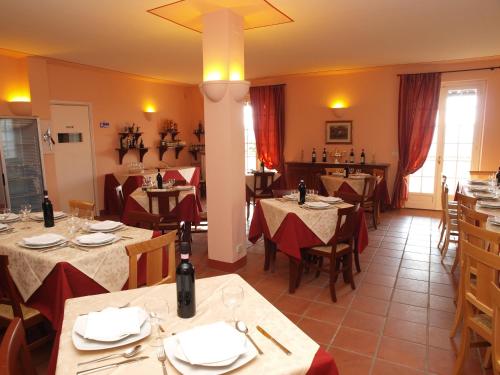 a restaurant with tables and chairs in a room at Agriturismo Sette Colli in Ferrere