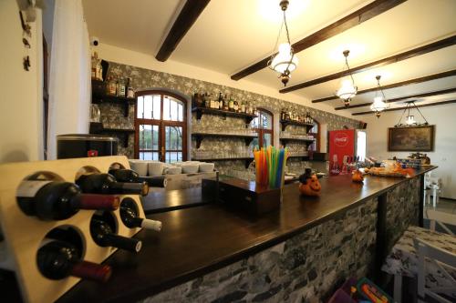 a bar with wine bottles on a stone wall at Restaurace a pension Chalupa in Vorder Třebau