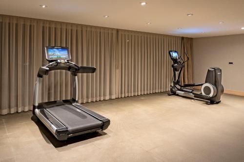 a gym with two exercise bikes and a treadmill at Sirene Luxury Hotel Bodrum in Yalıkavak