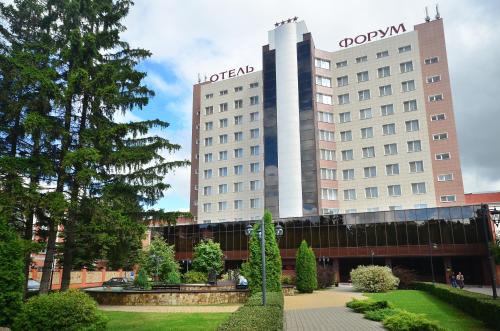 a large building with a clock on the top of it at Congress Hotel Forum in Ryazan