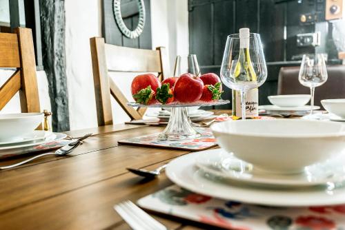 a table with a plate of strawberries on top of it at Burnside Hotel in Stratford-upon-Avon