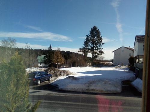 a car parked in a parking lot with snow at Pension Waldblick in Spiegelau