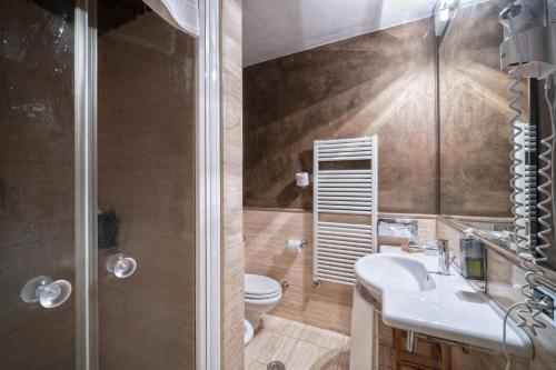 a bathroom with a toilet and a sink and a shower at Solo Experience Hotel in Florence