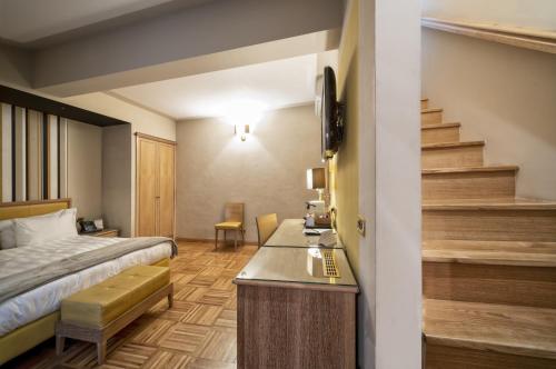 a hotel room with a bed and a staircase at Solo Experience Hotel in Florence