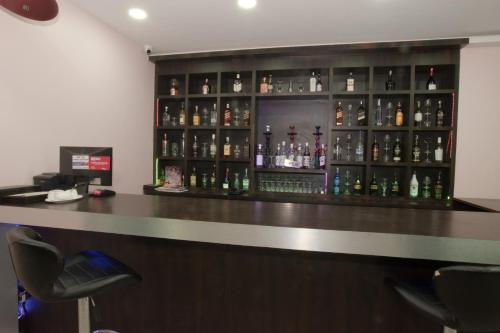 a bar with a lot of bottles of alcohol at Annapurna Hotel in Bīrganj